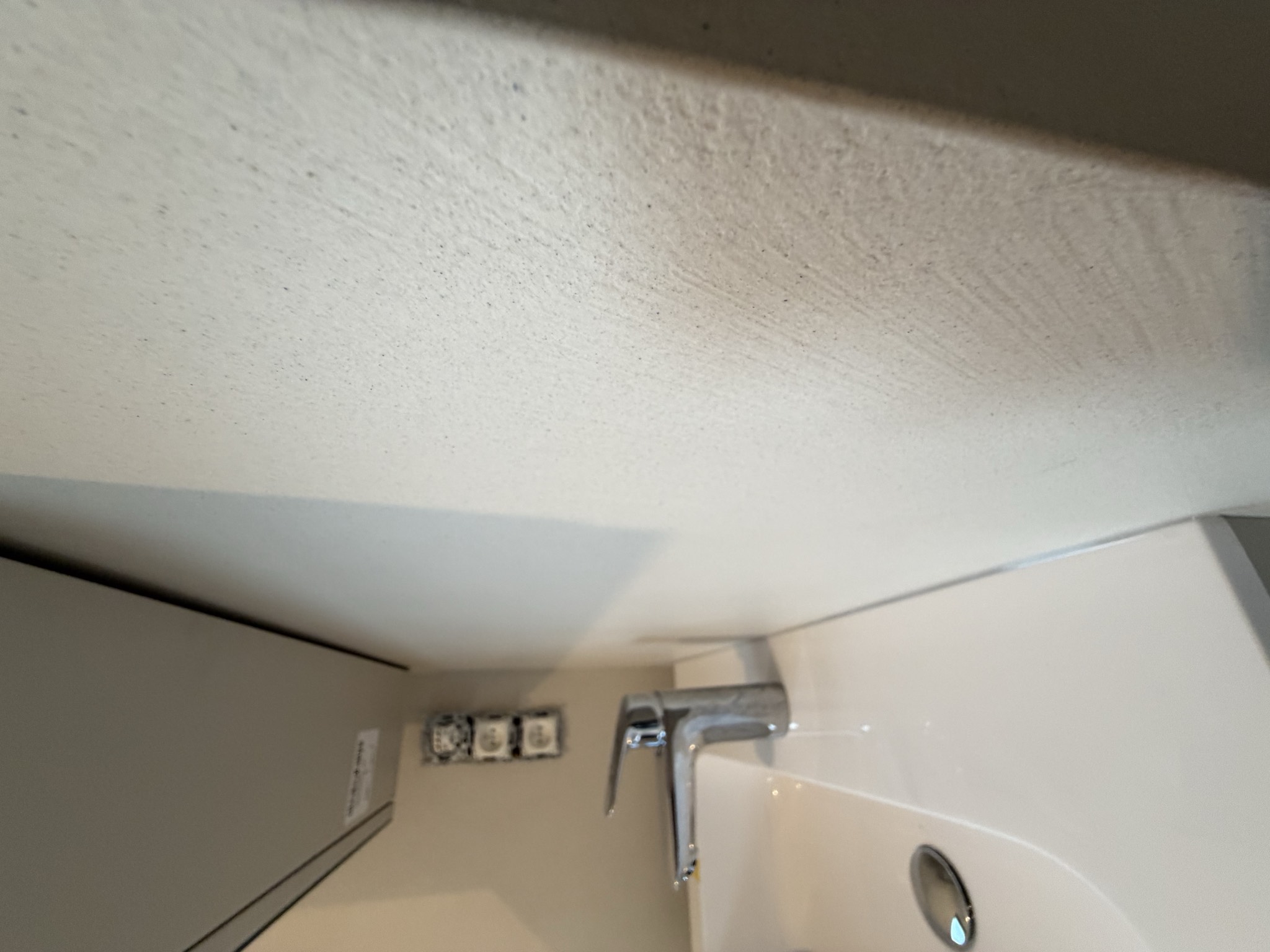 Microcement badmeubel met geveegde wandstructuur in detail